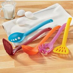 colorful kitchen utensils are sitting on a table