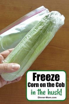 a person holding a bag of corn on the cob in their left hand, with text overlay reading freeze corn on the cob in the husk