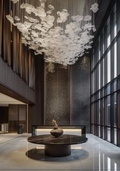 a large chandelier hanging from the ceiling in a lobby