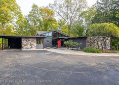 a large house in the middle of a wooded area