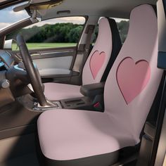 the interior of a car with two pink hearts on it's front seat covers