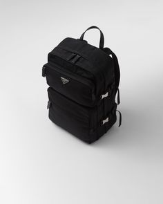 Black Re-Nylon and Saffiano leather backpack | PRADA Luxury Leather Bag With Logo Patch, Luxury Leather Bags With Logo Patch, Luxury Nylon Bags With Logo Patch, Luxury Nylon Backpack With Zipper Closure, Luxury Nylon Standard Backpack, Luxury Backpack With Functional Pockets, Designer Nylon Backpack For Travel, Designer Nylon Backpack For Everyday, Modern Travel Backpack With Logo Patch