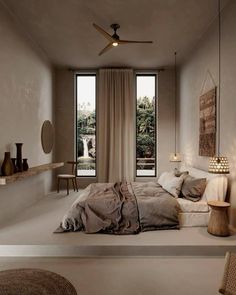 a bedroom with a bed and two windows