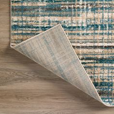 a blue and beige rug on the floor with a wooden flooring area in front of it