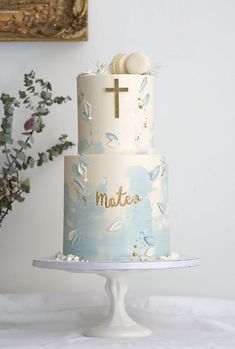 a blue and white cake with a cross on top