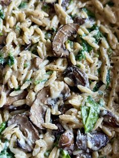 pasta with mushrooms, broccoli and spinach in a bowl