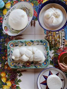 the table is covered with plates and bowls