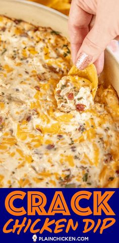 a hand dipping a tortilla chip into a casserole dish with chicken dip