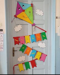 a door decorated with colorful kites and clouds