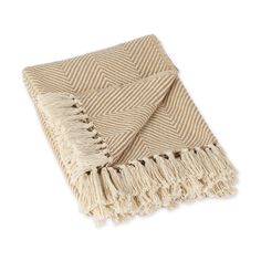 a tan and white blanket with fringes on it