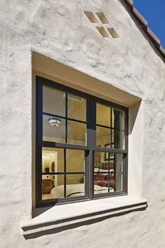 an open window on the side of a white building