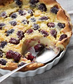 a berry pie with a serving spoon in it