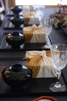 the table is set with dishes and glasses