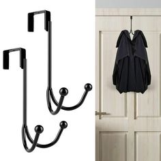 two hooks are hanging on the wall next to a coat rack and an open door