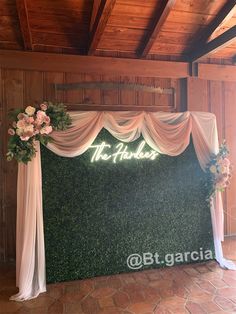 the wedding backdrop is decorated with flowers and greenery