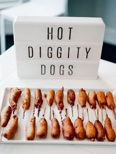 there are many sausages on the plate with toothpicks attached to them that say hot diggitty dogs