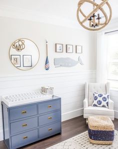 a baby's room with blue and white furniture