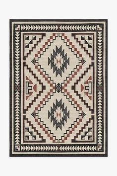 a black and white rug with an intricate design on the front, in different colors