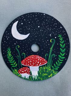 a painting of a mushroom on a black background with stars and the moon in the sky