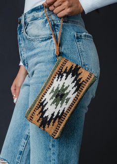 Stay organized and fashionable with our new Aztec inspired wristlet. This brown, black, green and cream Aztec inspired wristlet is a must have for the fall season ahead. Brown, black, green and cream Aztec inspired wristlet Leather pull Measures 5" x 8" Designed in the U.S.A. Produced in India.  100% Cotton Lining: 100% Polyester Paracord Knots, Knitted Hats Kids, Dangle Necklaces, Boho Fall, Modern Necklaces, Green Cream, Leather Pulls, Stay Organized, Fall Outfit