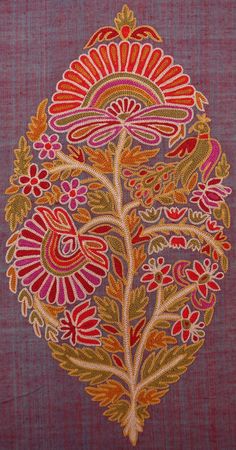 an embroidered design on a purple cloth with red flowers and leaves in the center,