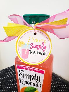 a bottle of simply lemonade sitting on top of a table next to a sign that says, you're simply the best