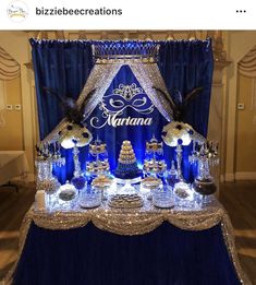 a blue and white dessert table with an elaborate sign on the top that says marinana