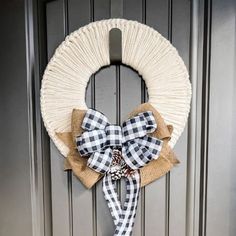 a wreath with a bow hanging on the front door, decorated with burlock