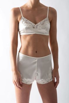 100% Silk Stretch Charmeuse  Color: Ivory Adjustable Straps Back Hook-and-Eye Closure Hand Wash  Imported Our adjustable Bella bralette is made from pure stretch silk and feels sumptuous against your bare skin. The scalloped lace detail is signature Miguelina. Wear it with our matching Nova shorts, wear it with our moh Silk Bralette, Rose Cardigan, Ruffle Sweater, Bare Skin, Lace Silk, October 23, Silk Shorts, Scalloped Lace, Color Ivory