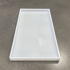 a square white tray on the ground