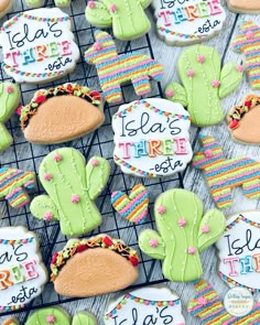 decorated cookies are on a cooling rack with the names of their favorite places and colors