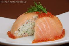 two pieces of salmon on a white plate with sauce and sprig of rosemary