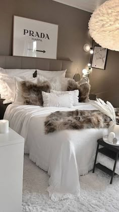 a bed with white sheets and pillows in a room