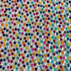 multicolored crocheted fabric with dots on it