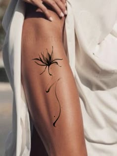 a woman's arm with a black spider tattoo on the left side of her body