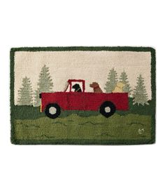 a door mat with a red truck and dog on it