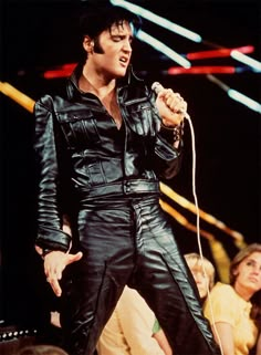 elvis presley performing on stage at an event