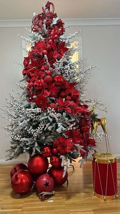 a christmas tree decorated with red and silver ornaments