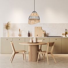 a table and chairs in a room with white walls, beige flooring and cabinets