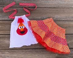 Elmo Personalized Birthday Girl Dress This cute custom boutique Elmo outfit would be perfect for an Elmo theme birthday or just a fun day out in the sun. Top is halter style with Elmo wearing a birthday hat on front and includes the number of your choice. Skirt is orange and red polka dot with red tulle underneath. You little one will love showing off her Elmo outfit on her special day. PLEASE INCLUDE NUMBER OF YOUR CHOICE TO GO ON ELMO'S HAT IN MESSAGE BOX UPON CHECK OUT. Elmo Theme 100% Cotton Birthday Girl Hat, Elmo Outfit, Elmo Dress, Toddler Birthday Outfit, Bug Clothing, Elmo Birthday, Bird Dress, Birthday Girl Dress, Birthday Girl Outfit