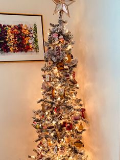 a white christmas tree decorated with ornaments and lights