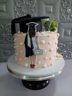 a cake decorated with an image of a woman in graduation cap and gown on it