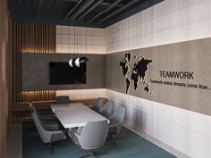 a conference room with a large white table and chairs in front of a sign that says teamwork