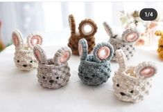 small crocheted rabbits sitting on top of a white table next to each other