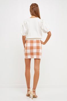 This Multi Gingham Knit Mini Skirt is sure to become a timeless favorite in your wardrobe. Expertly crafted with a luxe combination of gingham check and colorblock, this fitted mini skirt will take you from day to night in effortless style. The quality fabrication is machine washable and promises to keep you comfortable all day long. Enjoy this piece for years to come just give it a cold hand wash to keep it looking its best. Colorblock skirt Fitted mini skirt Gingham check Hand wash cold Do not Gingham Mini Skort For Spring, Spring Gingham Mini Skort, Fitted Gingham Mini Skirt, Spring Gingham Mini Skirt, Gingham Mini Skirt For Day Out, Chic Gingham Skirt For Work, White Mini Skirt With Houndstooth Pattern, Ivy Clothing, Fitted Mini Skirt