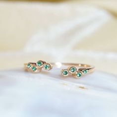 "Materials Gold, Rose gold, White gold Gemstone: Emerald 14k Gold Open Cuff Emerald Ring / Stackable Ring / Dainty Ring / Natural Emerald Ring / Emerald Stacking Ring / Open Ring / Solid Gold Ring Item Details ✔ Made to Order ✔ Gold Kt: 14K (also available in 18K) ✔ Available Gold Color: Rose Gold, Yellow Gold, White Gold ✔ Total ctw: 0.04Ctw ✔ Width of Band: 1 MM ✔ Ready to Ship in 7-10 Business Days * Also available in other gemstone colors please inquire If you have any additional questions a Fine Jewelry Rose Gold May Birthstone Ring, Fine Jewelry Rose Gold Birthstone Ring For May, Fine Jewelry Rose Gold Ring For May Birthstone, Rose Gold May Birthstone Ring In Fine Jewelry Style, Rose Gold Fine Jewelry Birthstone Ring For May, Rose Gold Emerald Open Ring Gift, Emerald Open Ring With Bezel Setting, Fine Jewelry May Birthstone Open Ring, Rose Gold Gemstone Stackable Open Rings