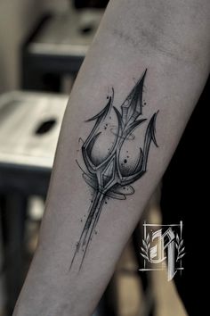 a black and white tattoo on the arm of a person with a knife in it