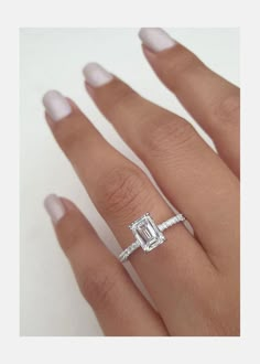 a woman's hand with an engagement ring on it and a diamond in the middle