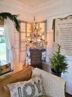 a living room with a christmas tree and potted plants on the wall next to it