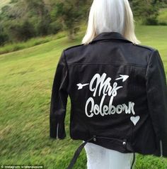 the back of a woman wearing a black leather jacket with mrs cobbleon written on it